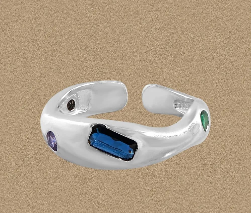 Polished sterling silver open-cuff ring with a blue rectangular gemstone and small purple and green stones