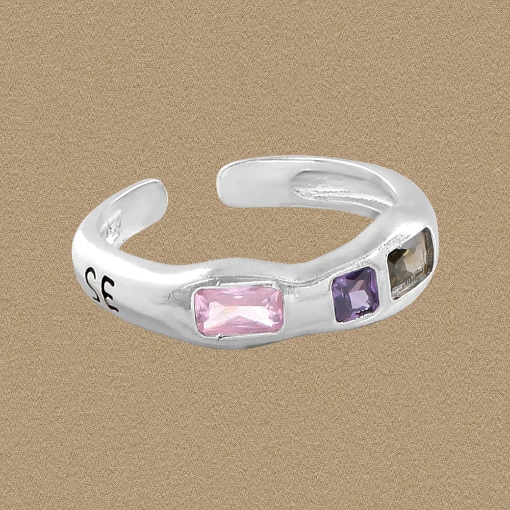 Polished silver open ring with three square-cut gemstones set along the band