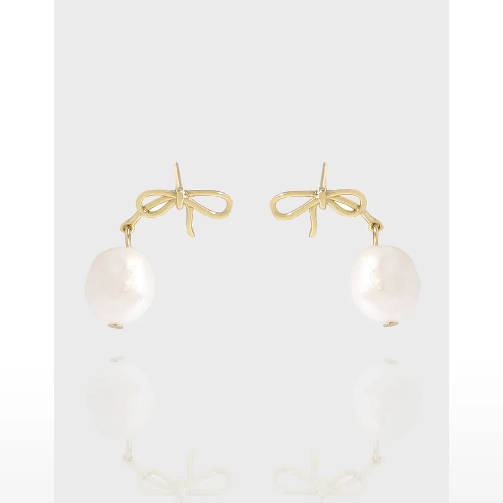 Gold-tone bow earrings with hanging freshwater pearl drops on a clean white background.