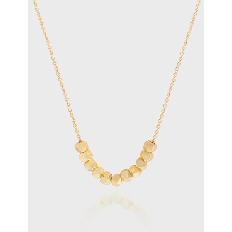 Polished sterling silver necklace with a curved row of round disc beads on the front.