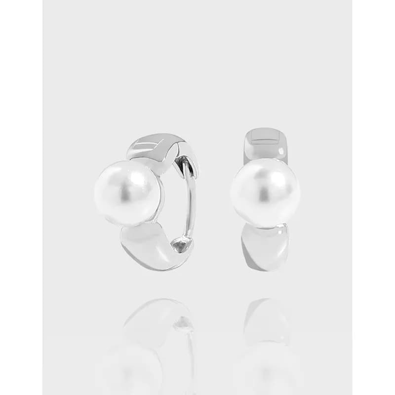 Polished sterling silver hoop earrings with a single pearl-like bead.