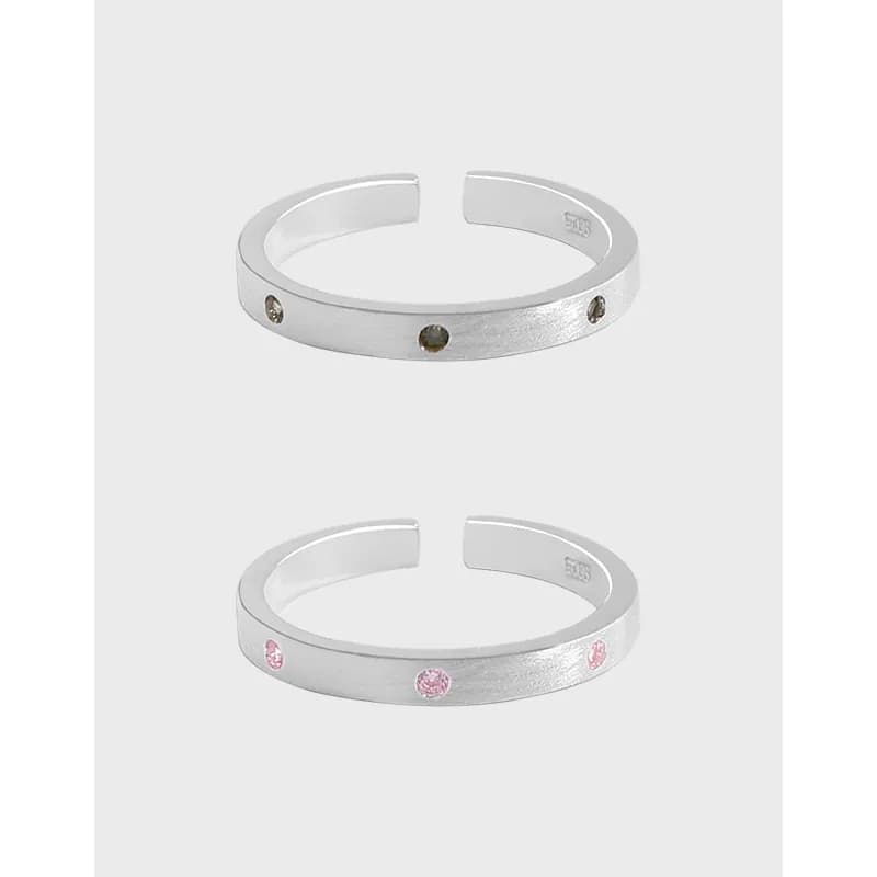 Polished sterling silver open-cuff ring with small pavé stones along the band
