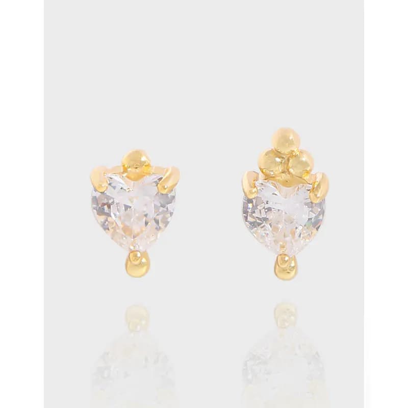 Polished sterling silver heart-shaped crystal earrings with gold-tone accents and drop detail.