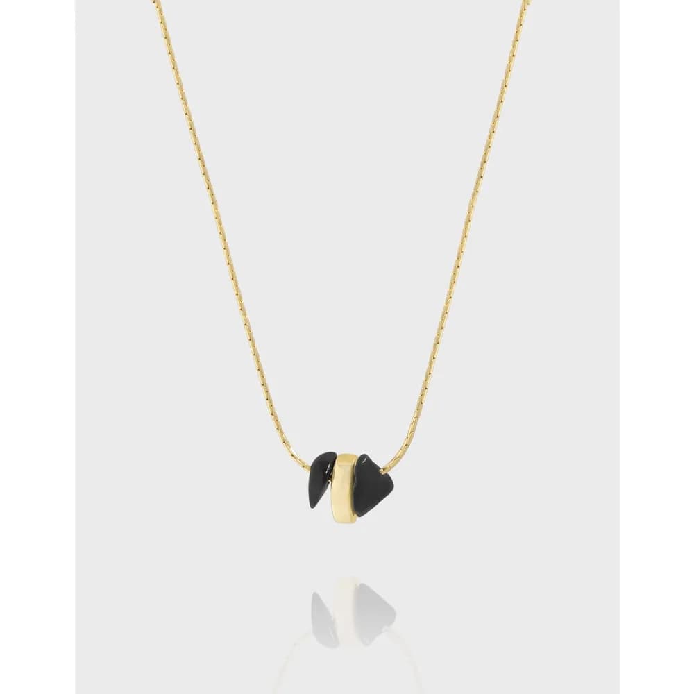 Delicate polished necklace with a small two-tone geometric pendant centered on the chain.