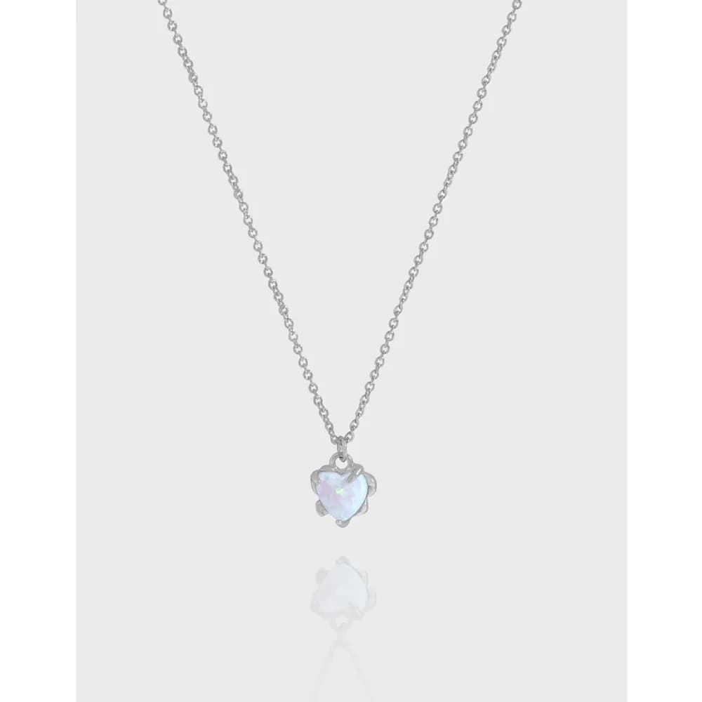Silver chain necklace with a heart-shaped iridescent pendant hanging at the center.