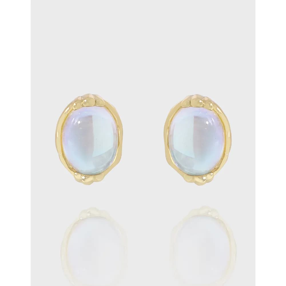 A pair of oval opalescent cabochon earrings in a polished sterling silver setting