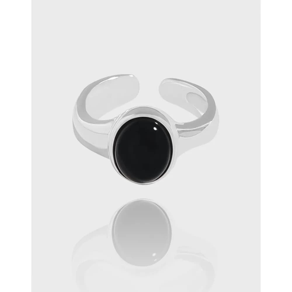 Polished sterling silver ring with a bezel-set oval black onyx cabochon