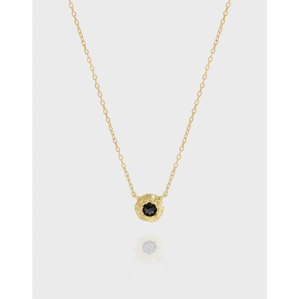 Delicate sterling silver necklace with a small black stone bezel-set pendant on a fine chain.