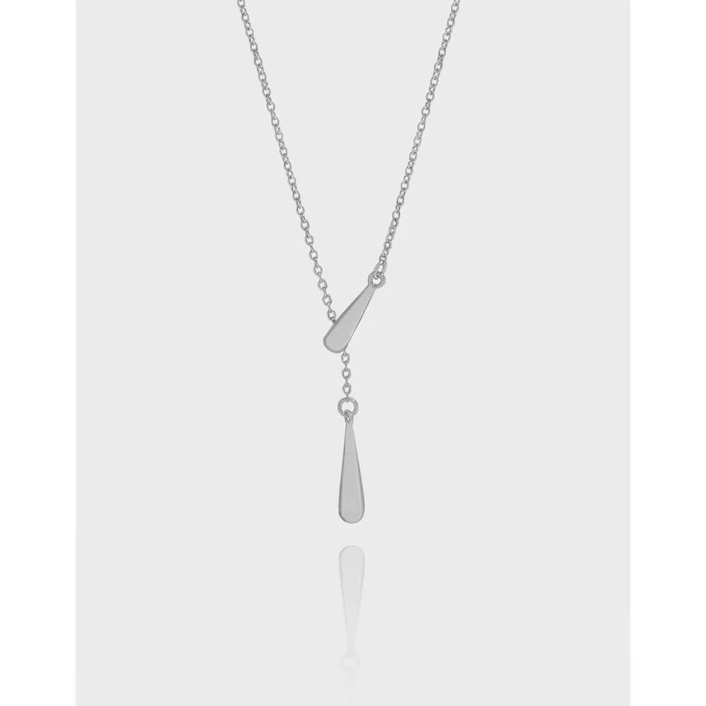 Sterling silver Y-shaped necklace with two teardrop pendants hanging against a pale background.