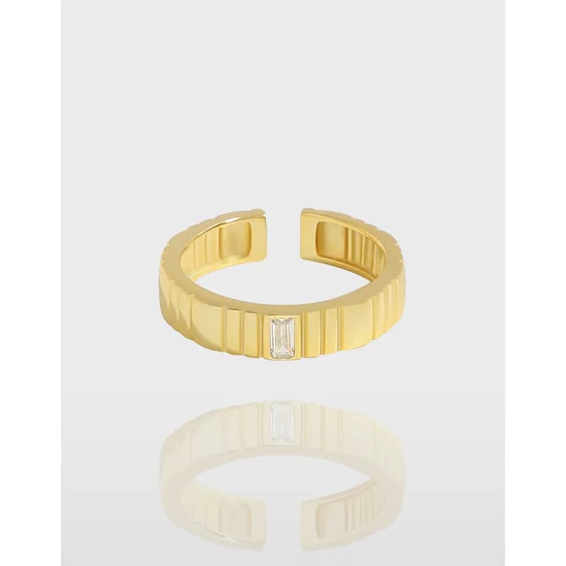 Polished ribbed ring with a central rectangular gemstone on a white background.