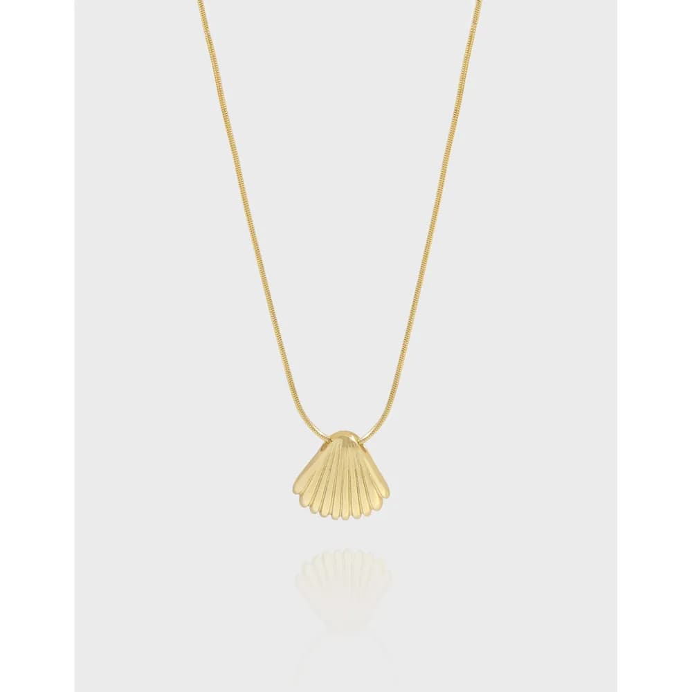 Gold shell pendant on a delicate chain necklace
