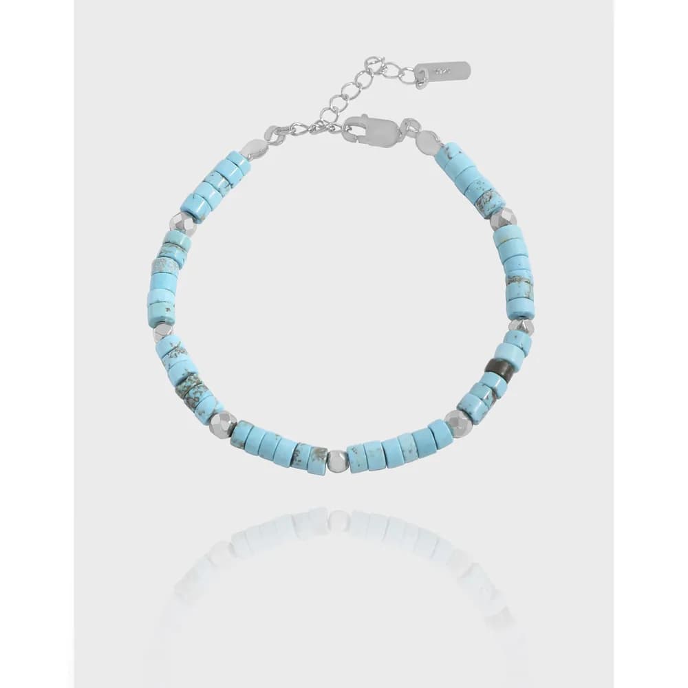 Sterling silver bracelet with light blue turquoise cylinder beads and silver spacers on an adjustable chain