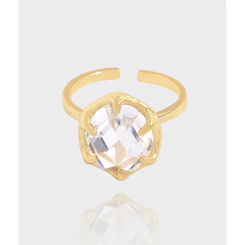 Polished sterling silver ring with a large faceted crystal held by claw-like prongs