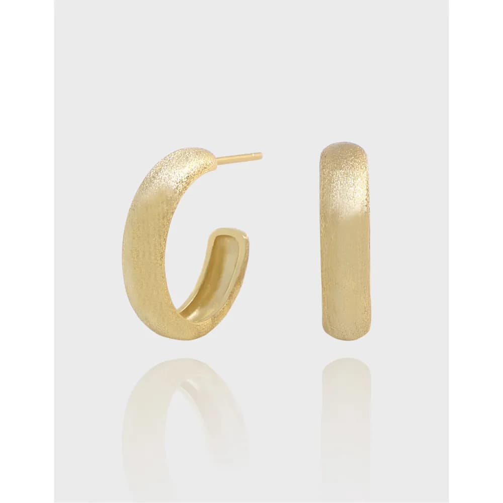 Textured gold-toned hoop and rectangular bar stud earrings shown together against a light background.