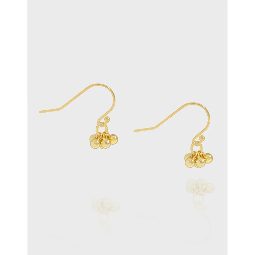 Polished sterling silver earrings with a tiny four-bead cluster hanging from a curved hook.