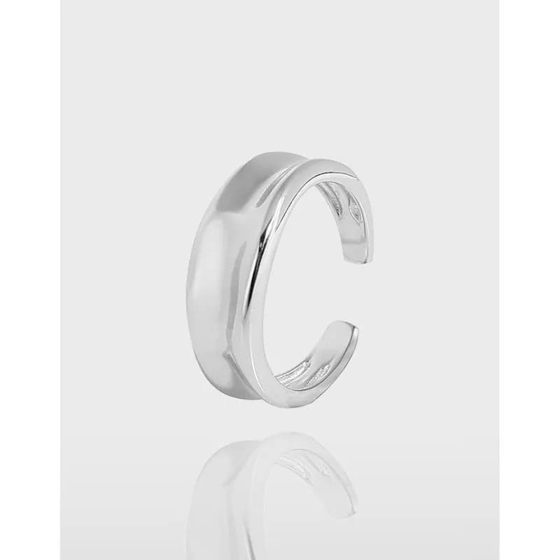 Polished curved wide sterling silver ring with an open gap and smooth reflective surface.