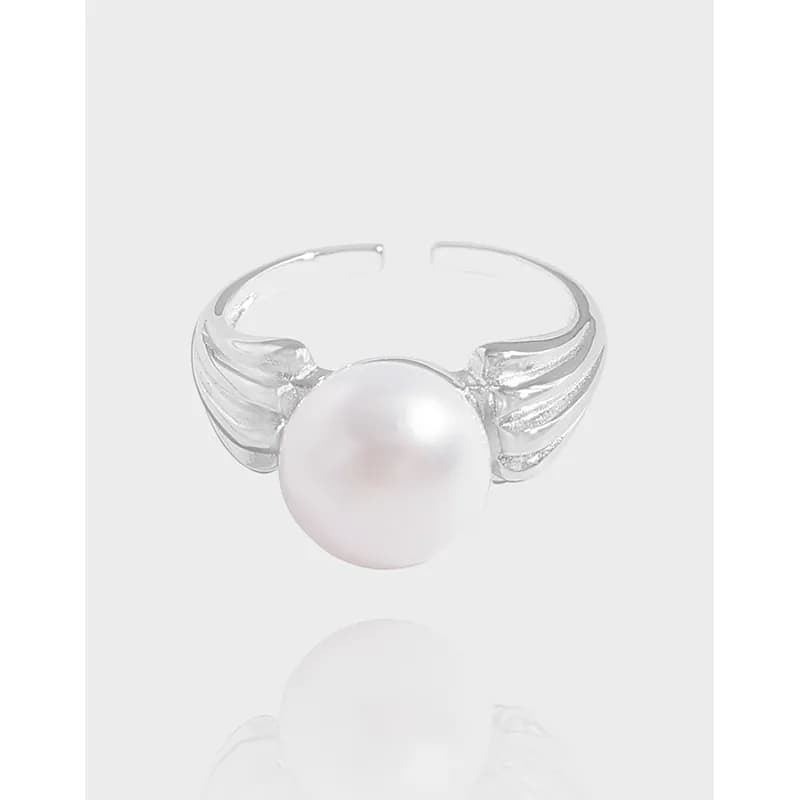 Polished sterling silver ring with a large white pearl centerpiece and split ribbed shank.