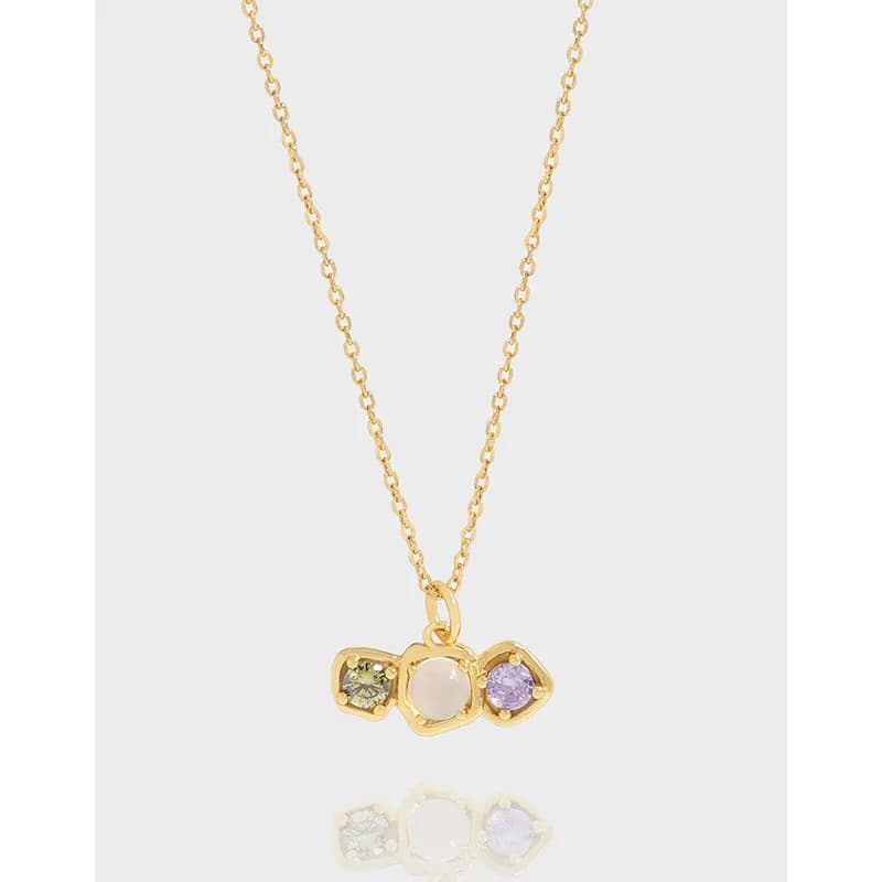 Delicate necklace with a three-stone bezel pendant on a fine chain