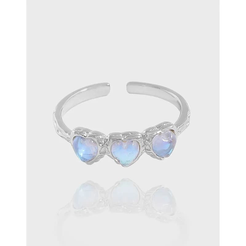 Polished sterling silver ring with three heart-shaped opals set in a row