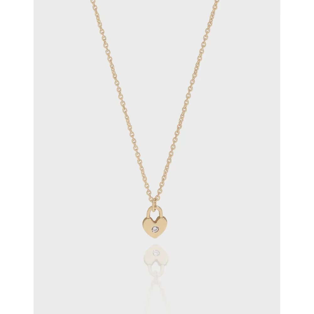 Delicate sterling silver heart pendant on a fine chain against a soft, light background.