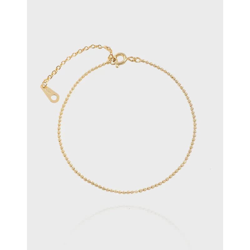 Delicate beaded sterling silver bracelet with a spring ring clasp and adjustable chain on a clean white background.