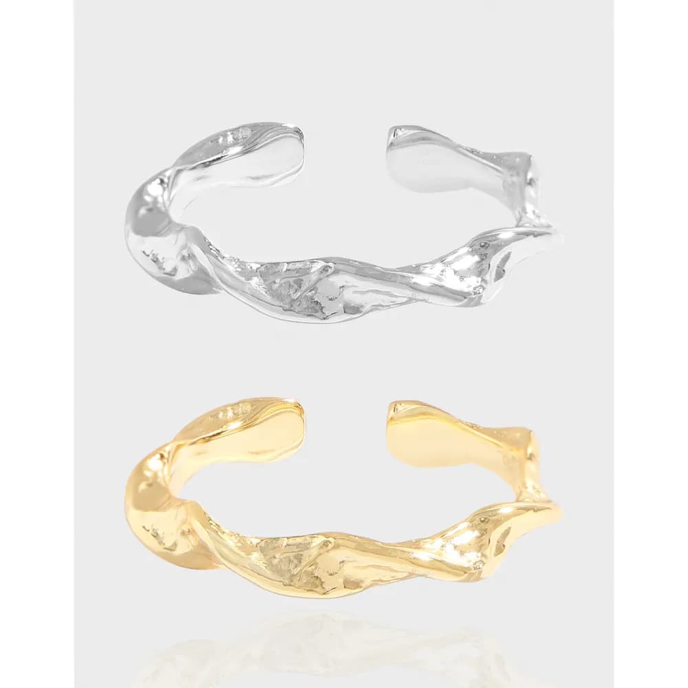 Two open-ended rings, one silver and one gold, featuring an organic twisted band design.