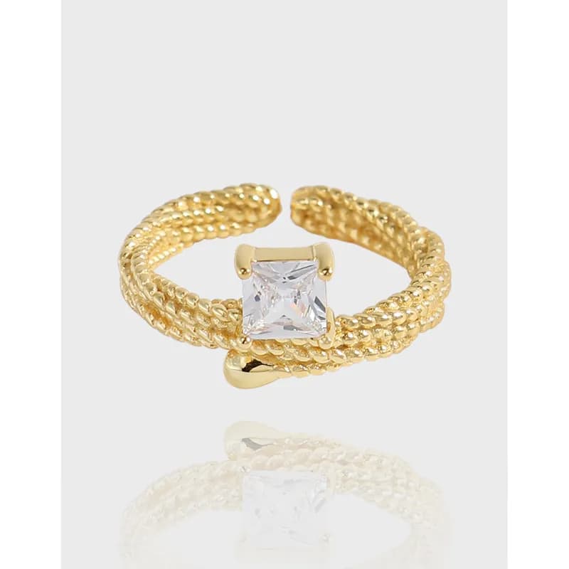 Polished sterling silver rope ring with a square-cut crystal centerpiece and twisting bands