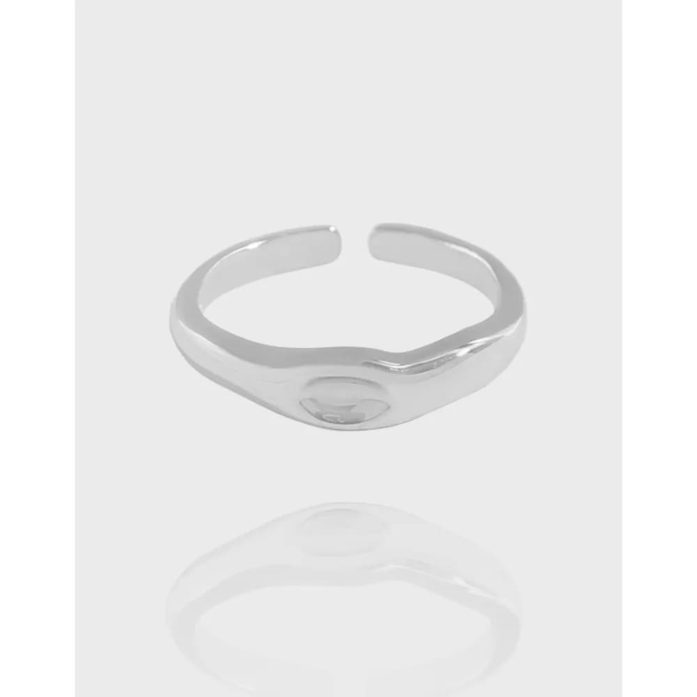 Polished sterling silver open-ring with a small domed bezel on top.
