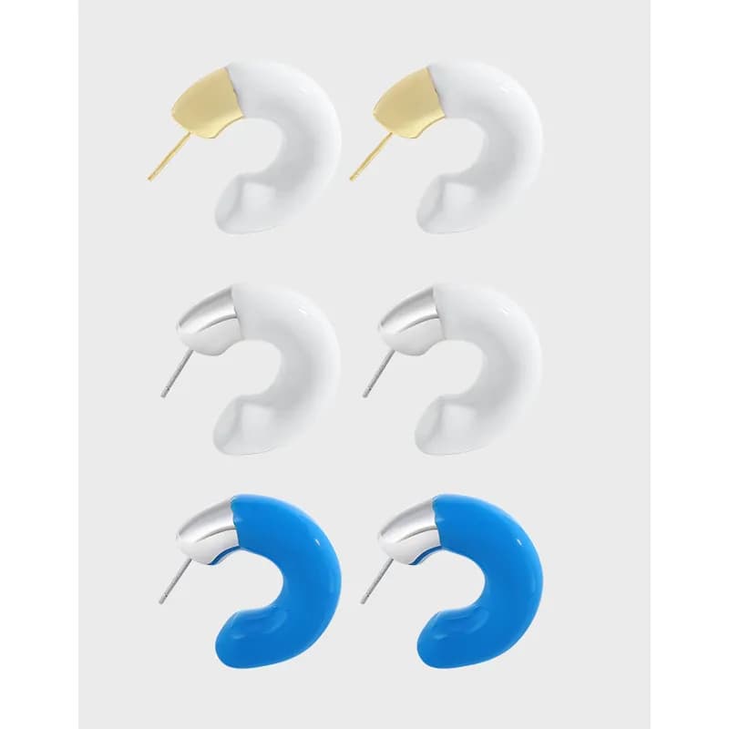 Crescent hoop earrings in white and blue resin with metal caps and silver posts.
