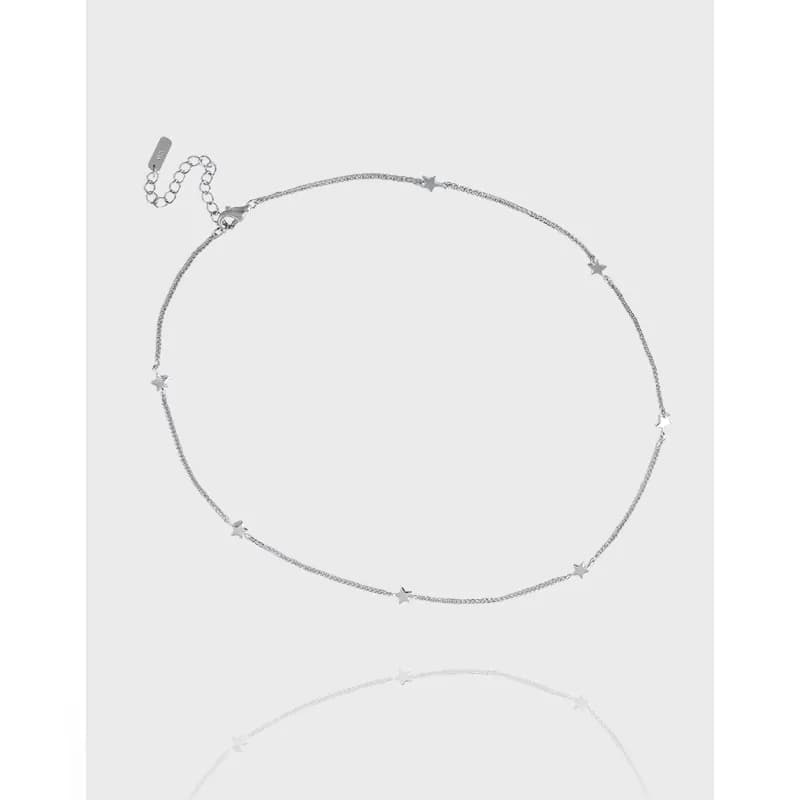 Delicate sterling silver necklace with star charms arranged along a fine chain