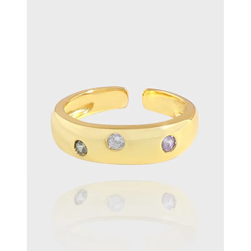 Open-ended polished sterling silver ring with three bezel-set stones along the top