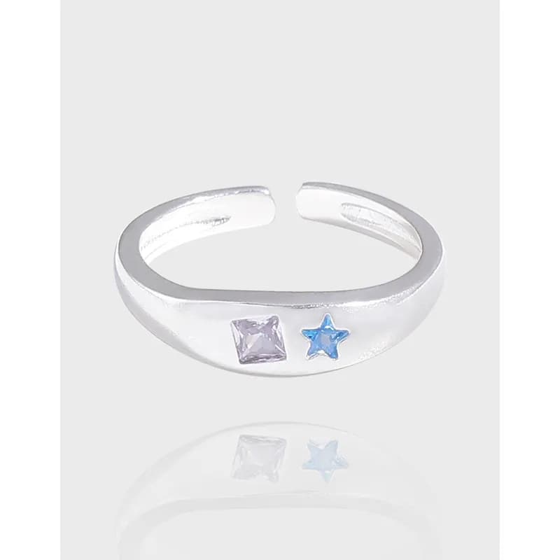 Open-ended sterling silver ring with a square purple stone and a blue star accent