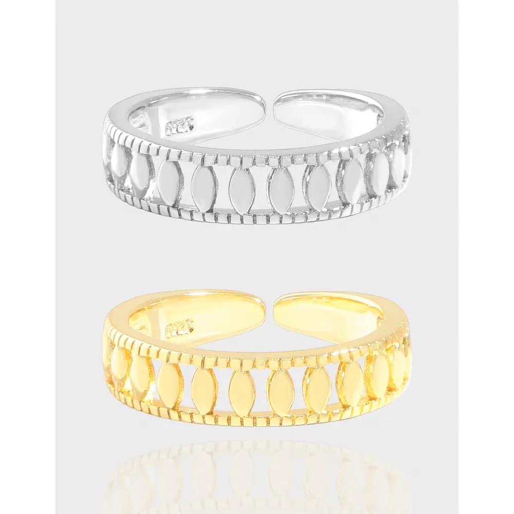 Polished ring with repeating oval cut-out pattern along the band