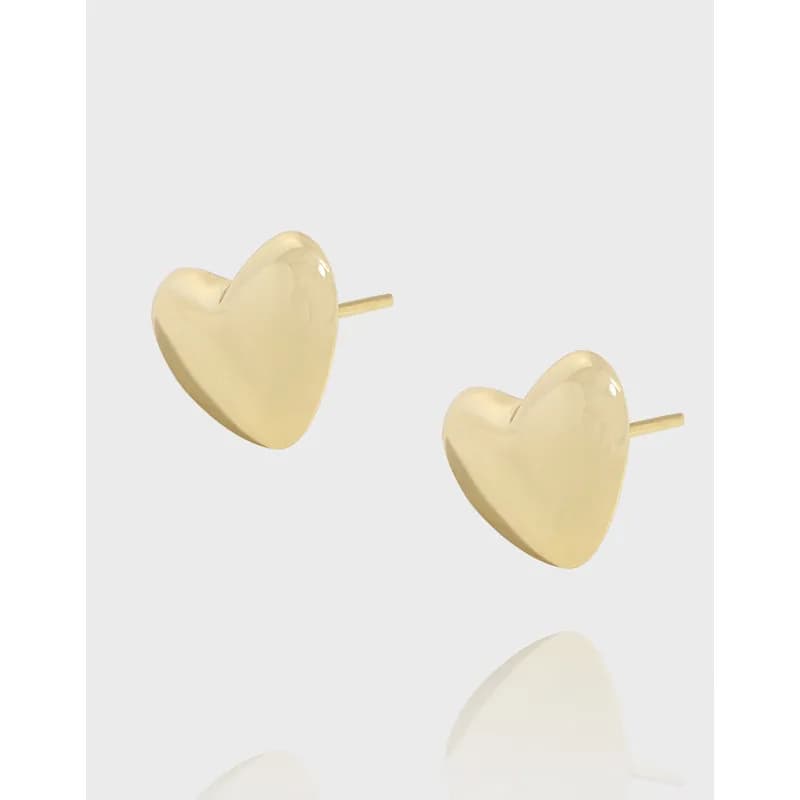 Polished heart-shaped stud earrings with posts shown on a light background.