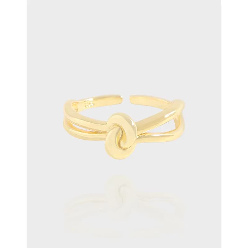 Open adjustable ring in polished sterling silver with a central knot motif