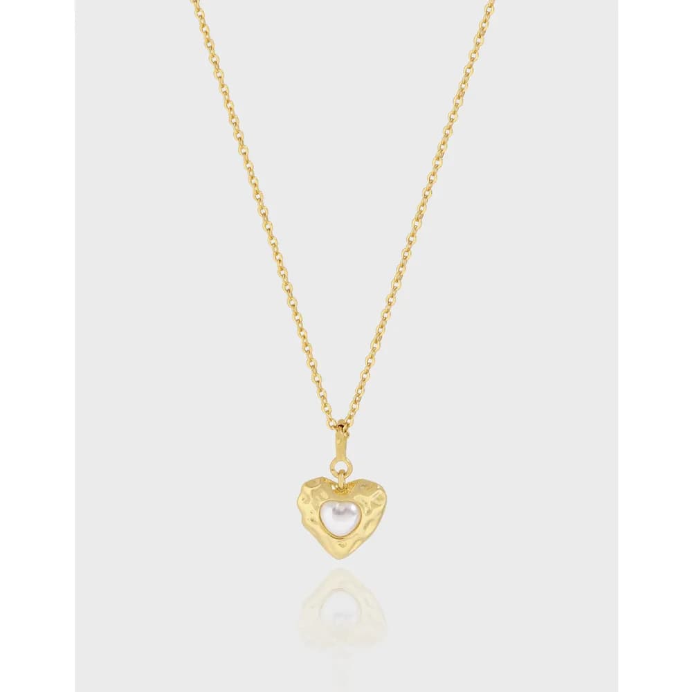 Polished sterling silver necklace with a heart pendant featuring a central white pearl