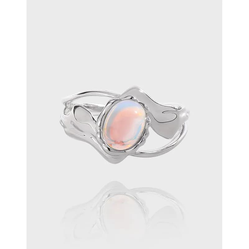 Polished sterling silver ring with oval opal cabochon in a leaf-inspired, sculptural setting.