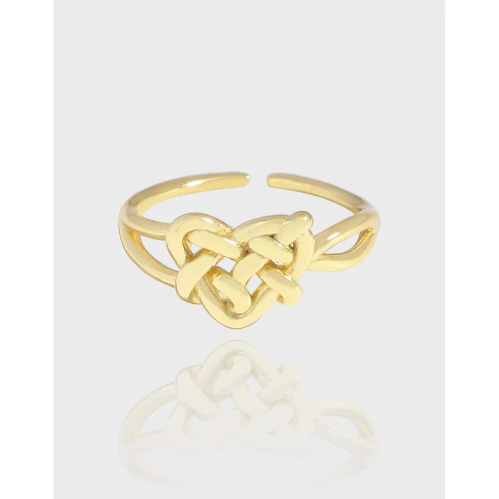 Polished sterling silver ring with a central knot forming a heart-like motif