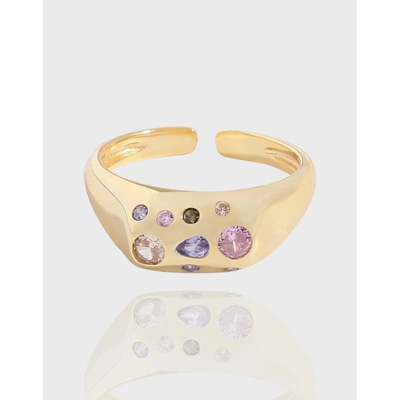 Polished gold-tone sterling silver ring with a scatter of pastel gemstones set on the top