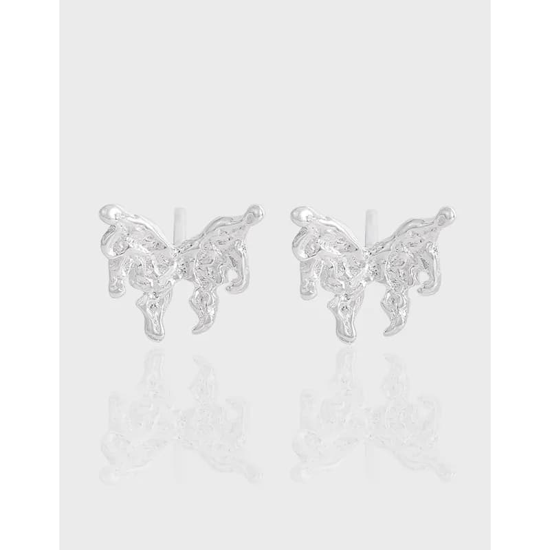 Polished sterling silver abstract butterfly-shaped stud earrings on a light background.