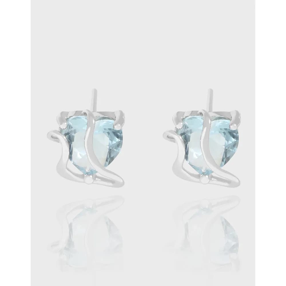 Pair of sterling silver earrings with pale blue gemstones and curved ribbon design