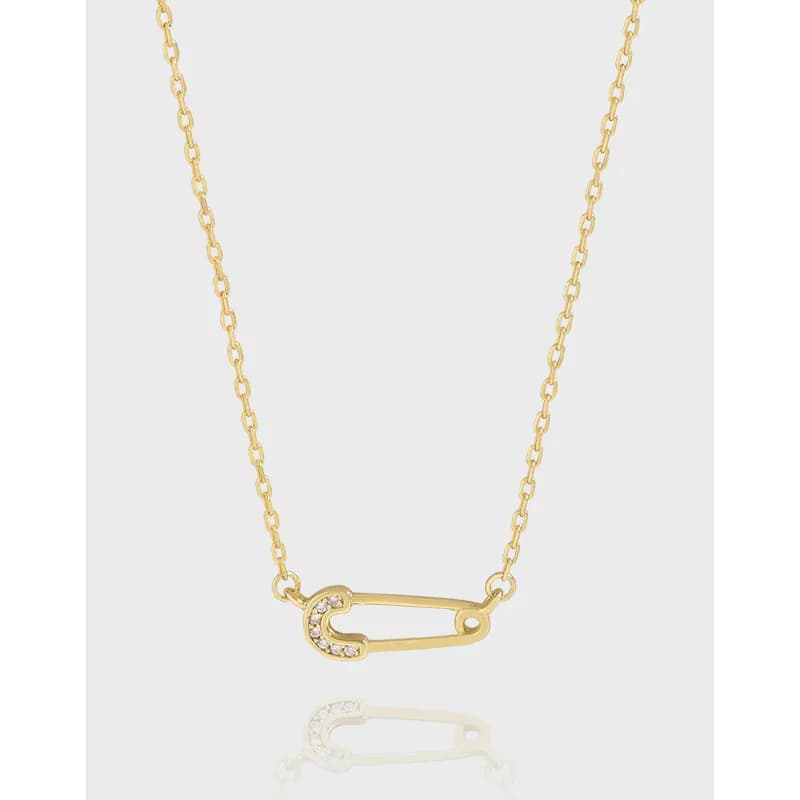 Polished sterling silver necklace with a crystal-studded safety-pin pendant on a slim chain.