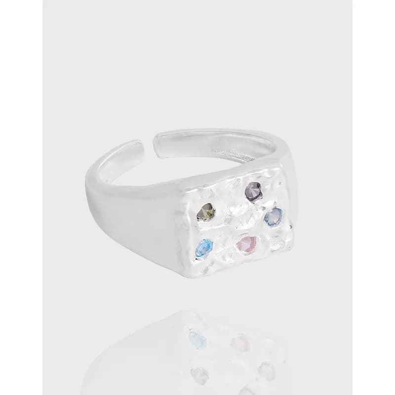 Polished sterling silver ring with a square top featuring six pastel gemstones in a grid