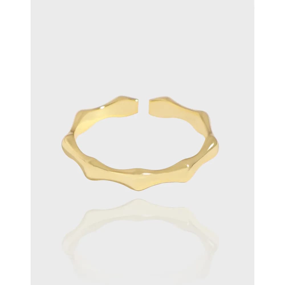 Open-ended wavy ring in polished sterling silver with a smooth reflective surface.