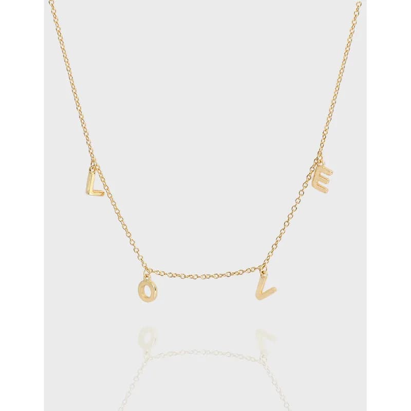 Delicate sterling silver necklace with four small letter charms forming the word LOVE on a fine chain.