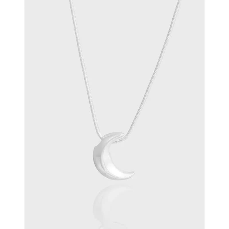 Polished sterling silver crescent pendant on a delicate chain.