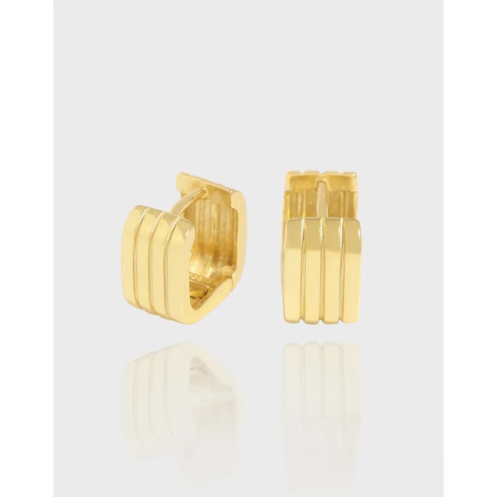 Polished gold-tone sterling silver triple-ridge hoop earrings with hinged backs on a white background.