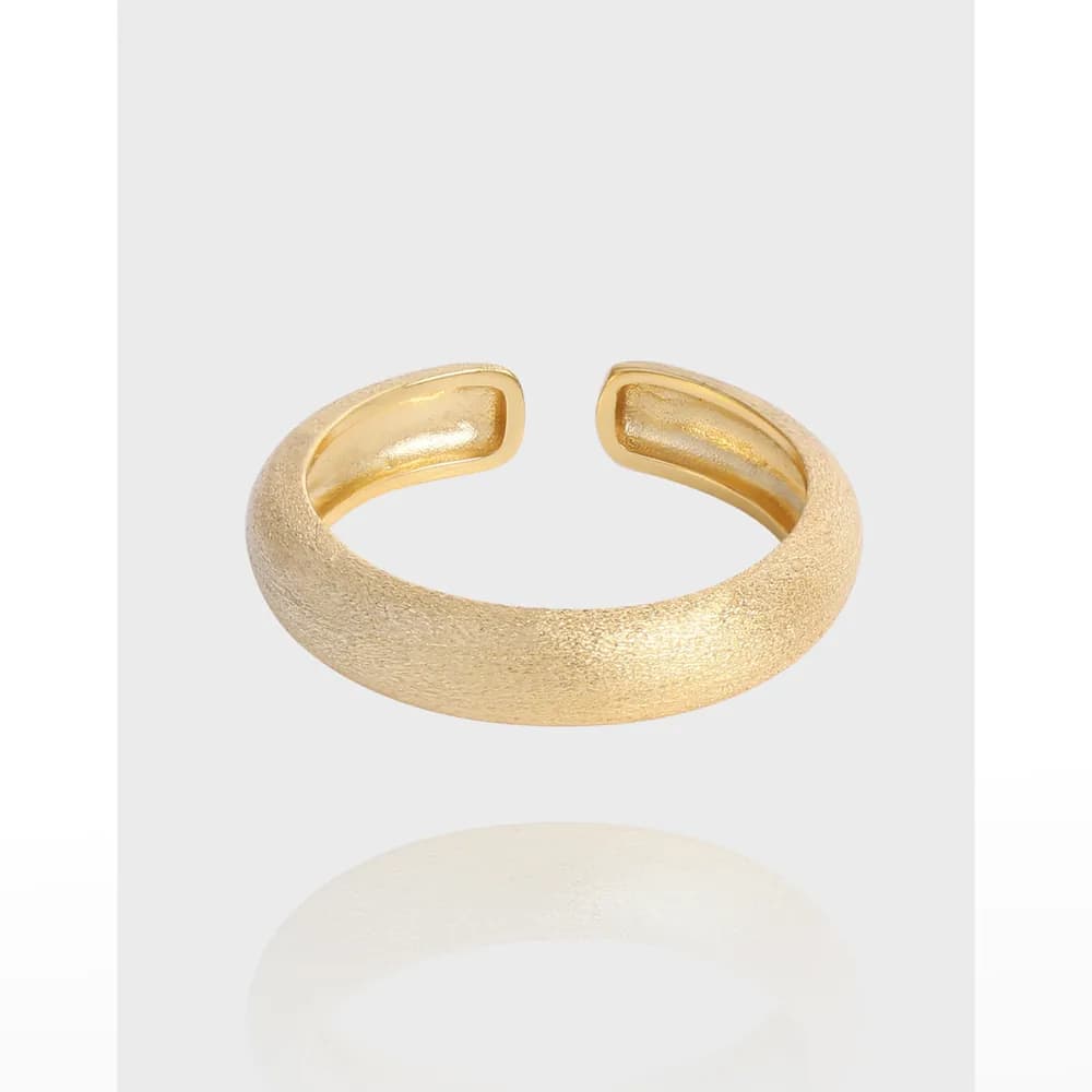 Open-ended textured sterling silver ring with a curved, wide band and matte finish