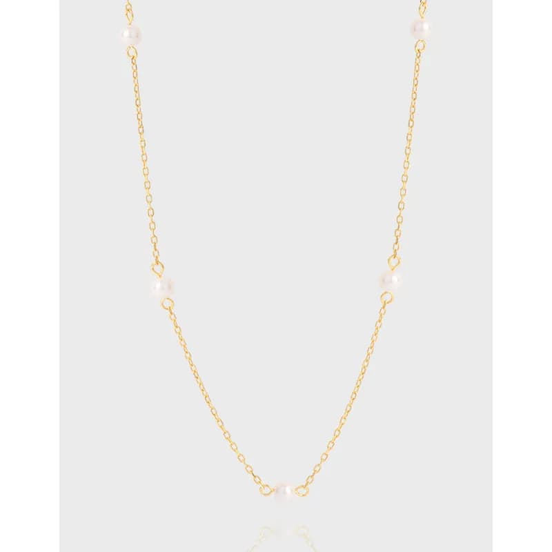 Delicate sterling silver necklace with small pearl beads spaced along a fine chain.