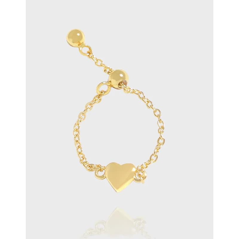 Polished sterling silver ring with a small heart charm on a delicate chain design